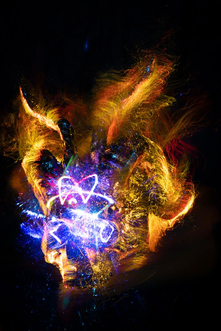 Fiery explosion with luminous colors and dynamic energy in an abstract art style.