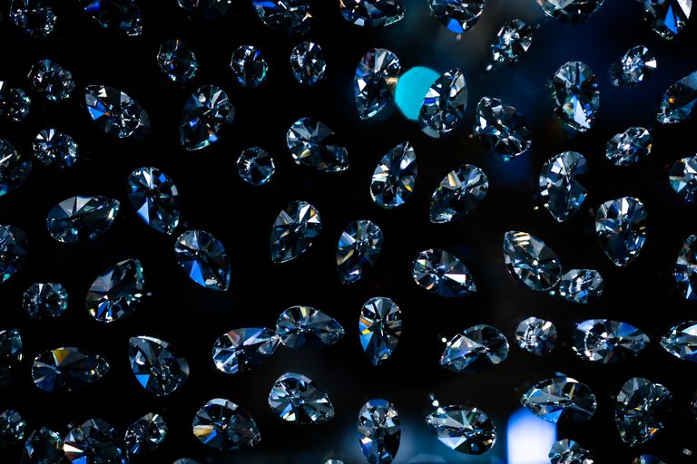 Glistening diamonds floating against a dark background, showcasing elegance and luxury.